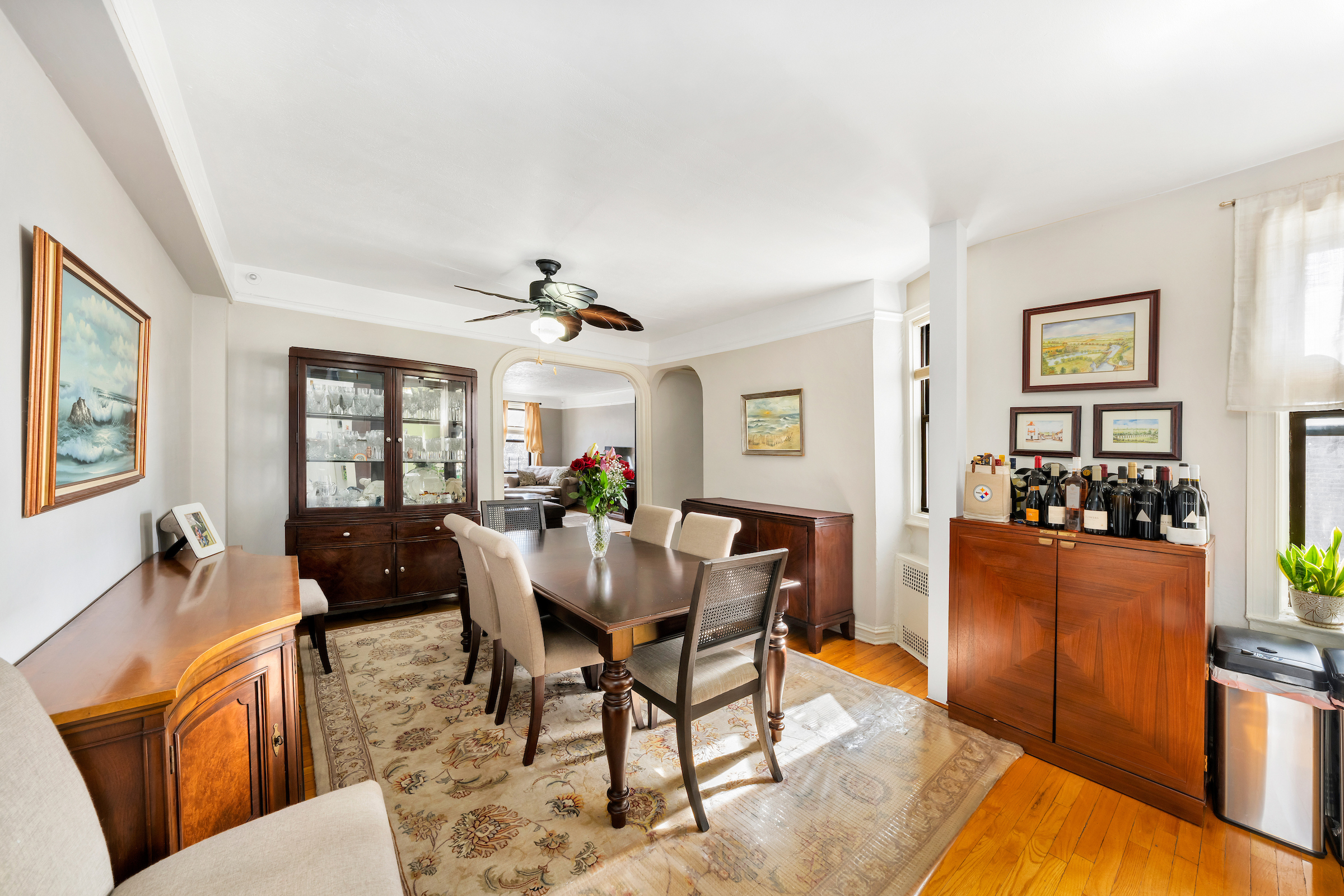 a view of a dining room with furniture a rug and wooden floor