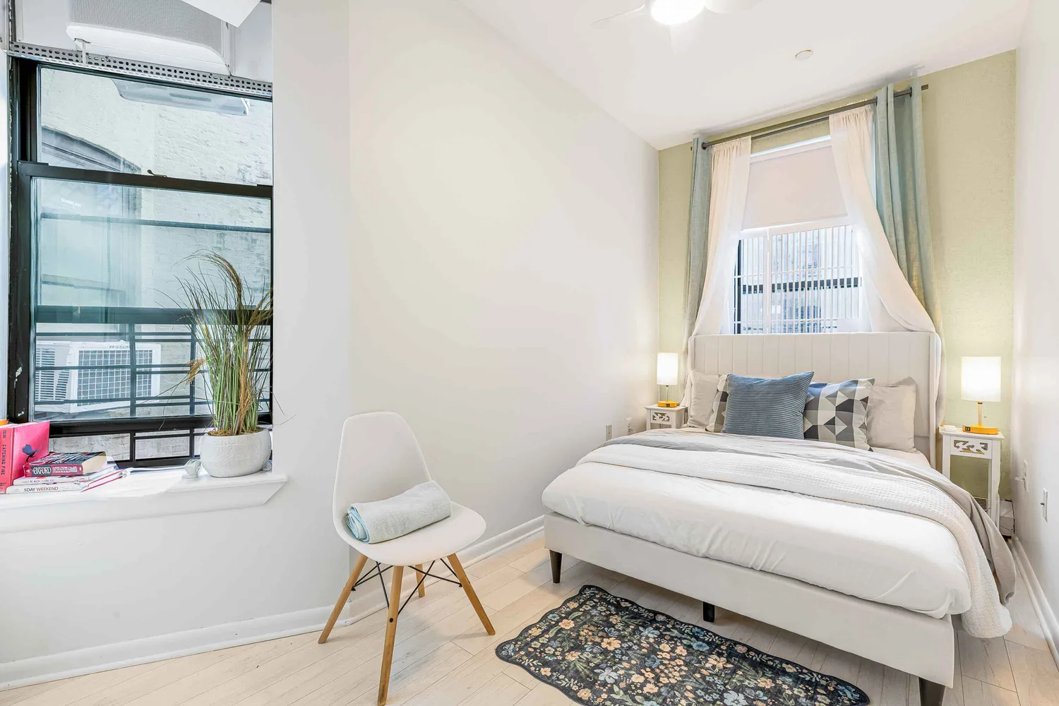 a bedroom with a bed and glass window