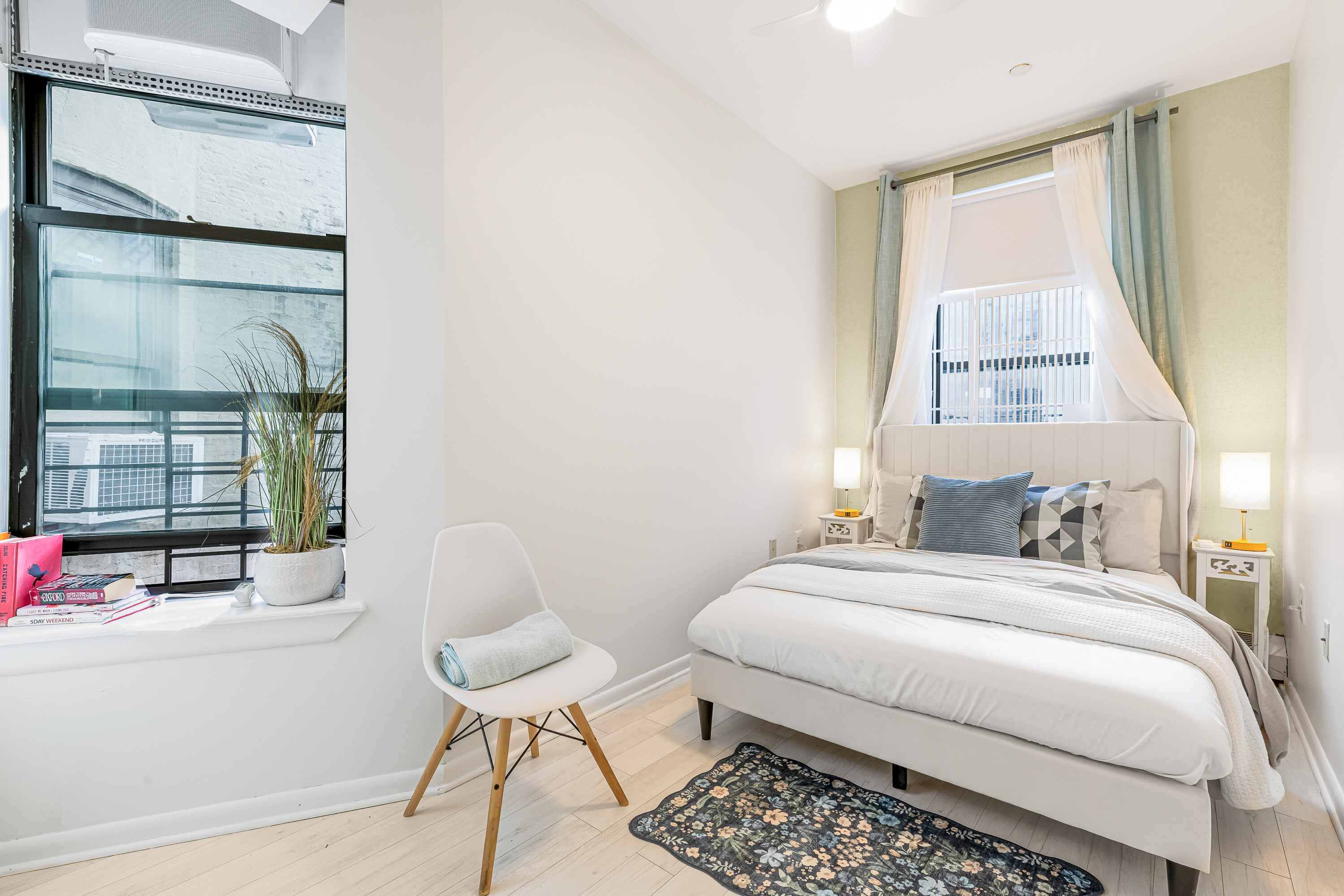 108 West 114th Street, Unit 4B Manhattan, NY 10026 - Photo 5 of 11 a bedroom with a bed and glass window
