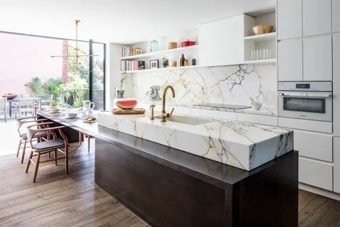 a kitchen with a sink cabinets and wooden floor
