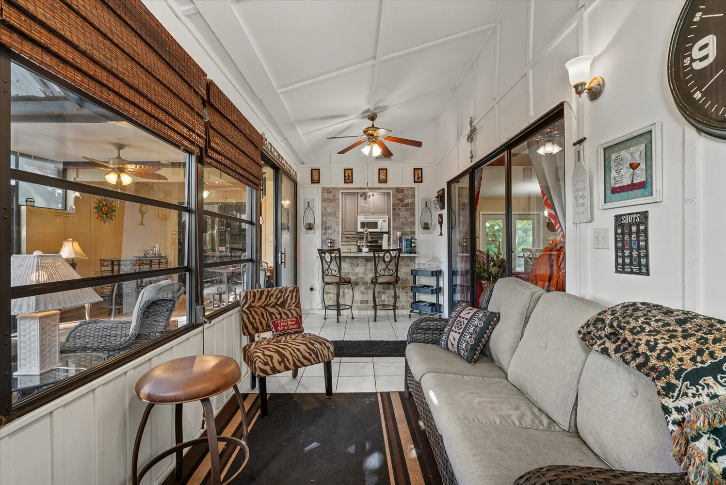 a living room with furniture a lamp and a large window