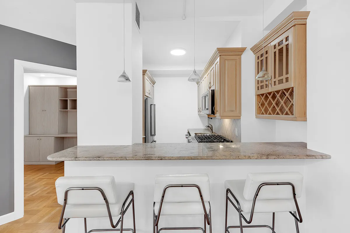 200 East 58th Street, Unit 15B Manhattan, NY 10022 - Photo 4 of 10 a bathroom with a granite countertop sink and a mirror