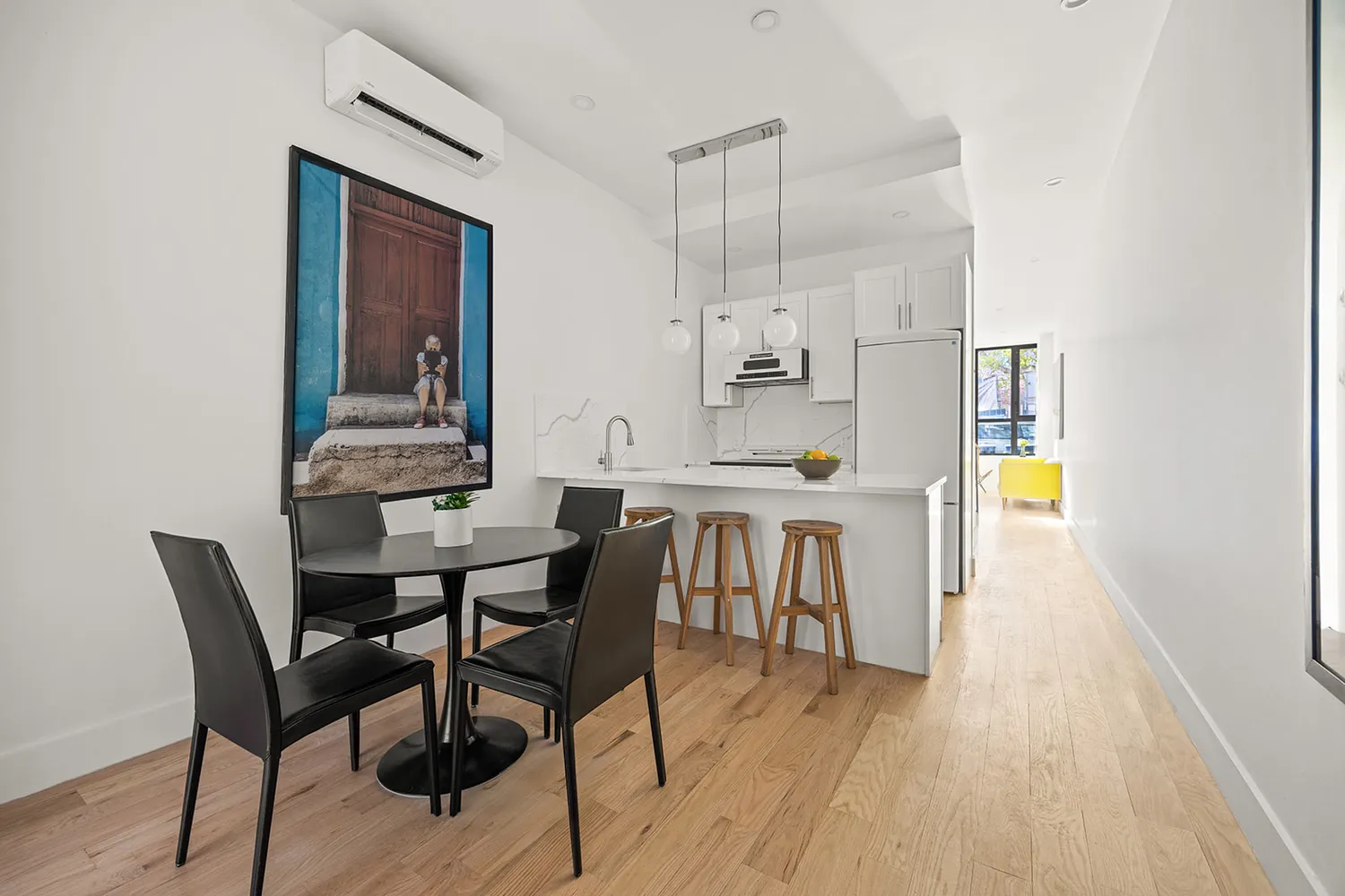 a view of a dining room with furniture and wooden floor