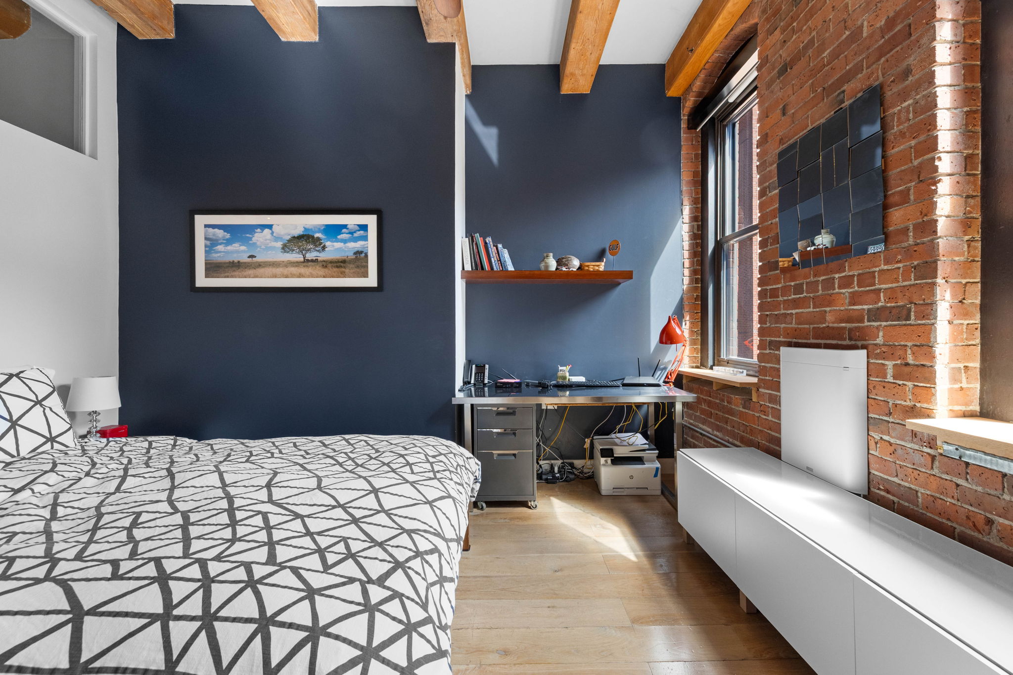 33 Sleeper Street, Unit 307 Boston, MA 02210 - Photo 13 of 15 a bedroom with a bed and a couch