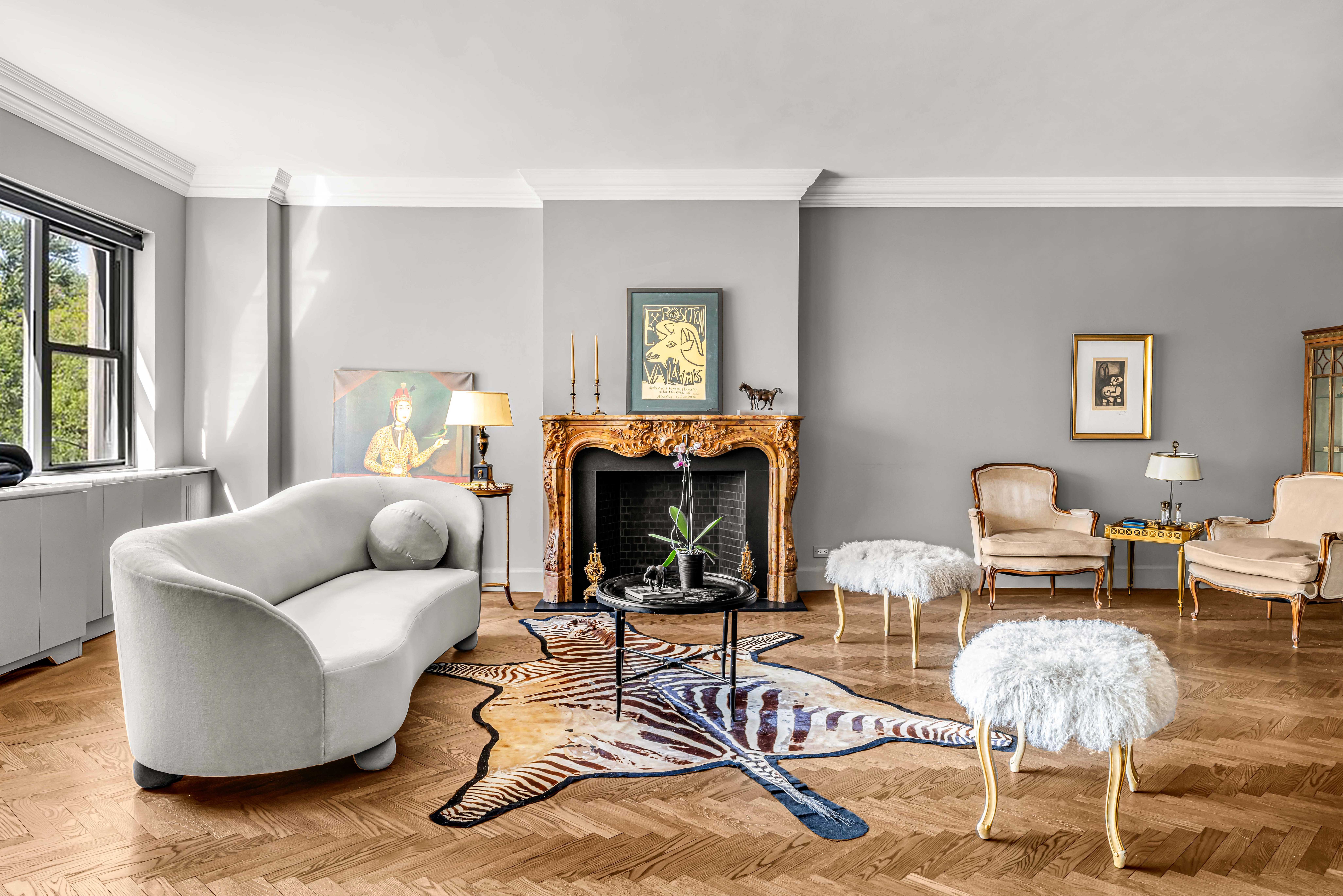 785 5th Avenue, Unit 3C Manhattan, NY 10022 - Photo 2 of 16 a living room with furniture and a fireplace