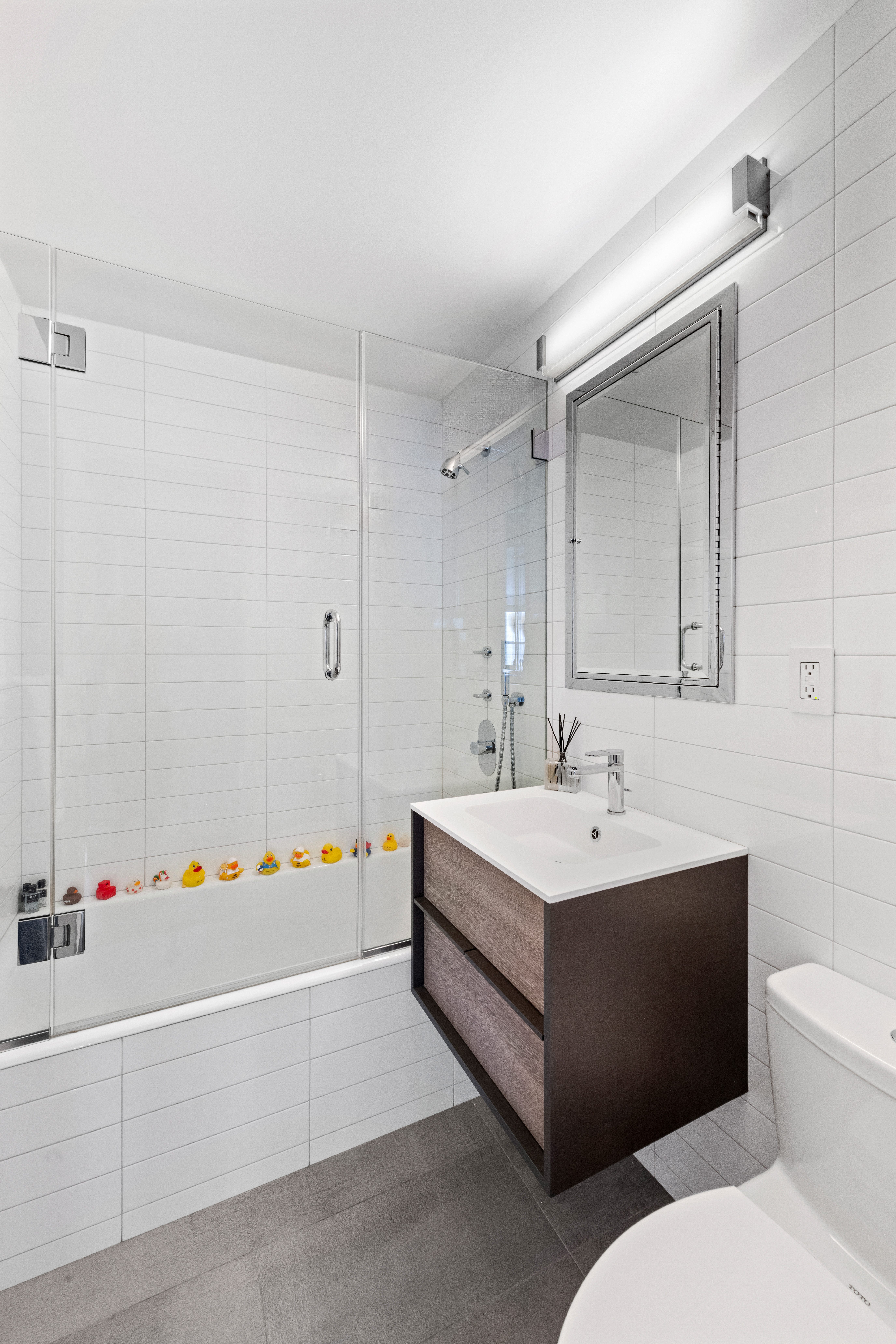 363 East 76th Street, Unit 7C Manhattan, NY 10021 - Photo 10 of 19 a bathroom with a sink and a mirror