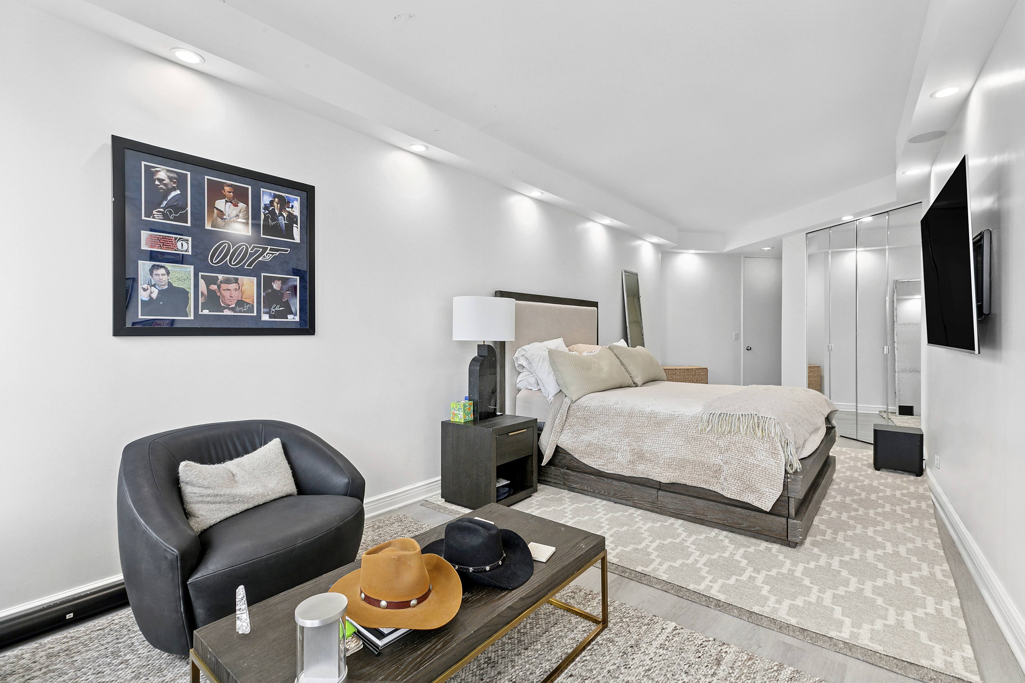 146 West 57th Street, Unit 47B Manhattan, NY 10019 - Photo 7 of 15 a bed room with furniture and a flat screen tv