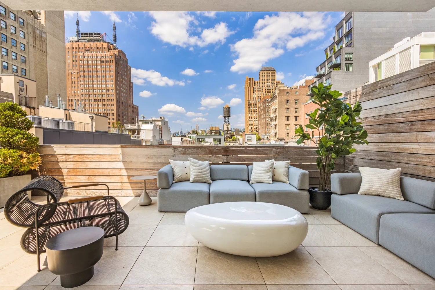 a view of a patio with couches and potted plants
