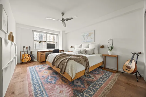 a bedroom with a bed and wooden floor