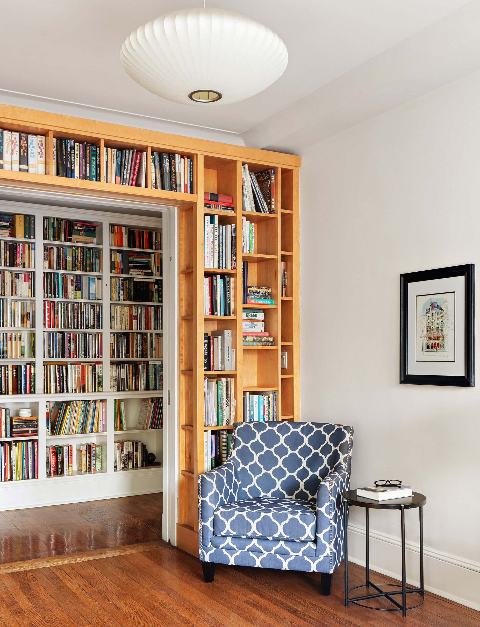 136 East 36th Street, Unit 9/10C Manhattan, NY 10016 - Photo 10 of 16 a living room with a couch and bookshelf