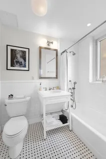 a bathroom with a sink a toilet and bathtub