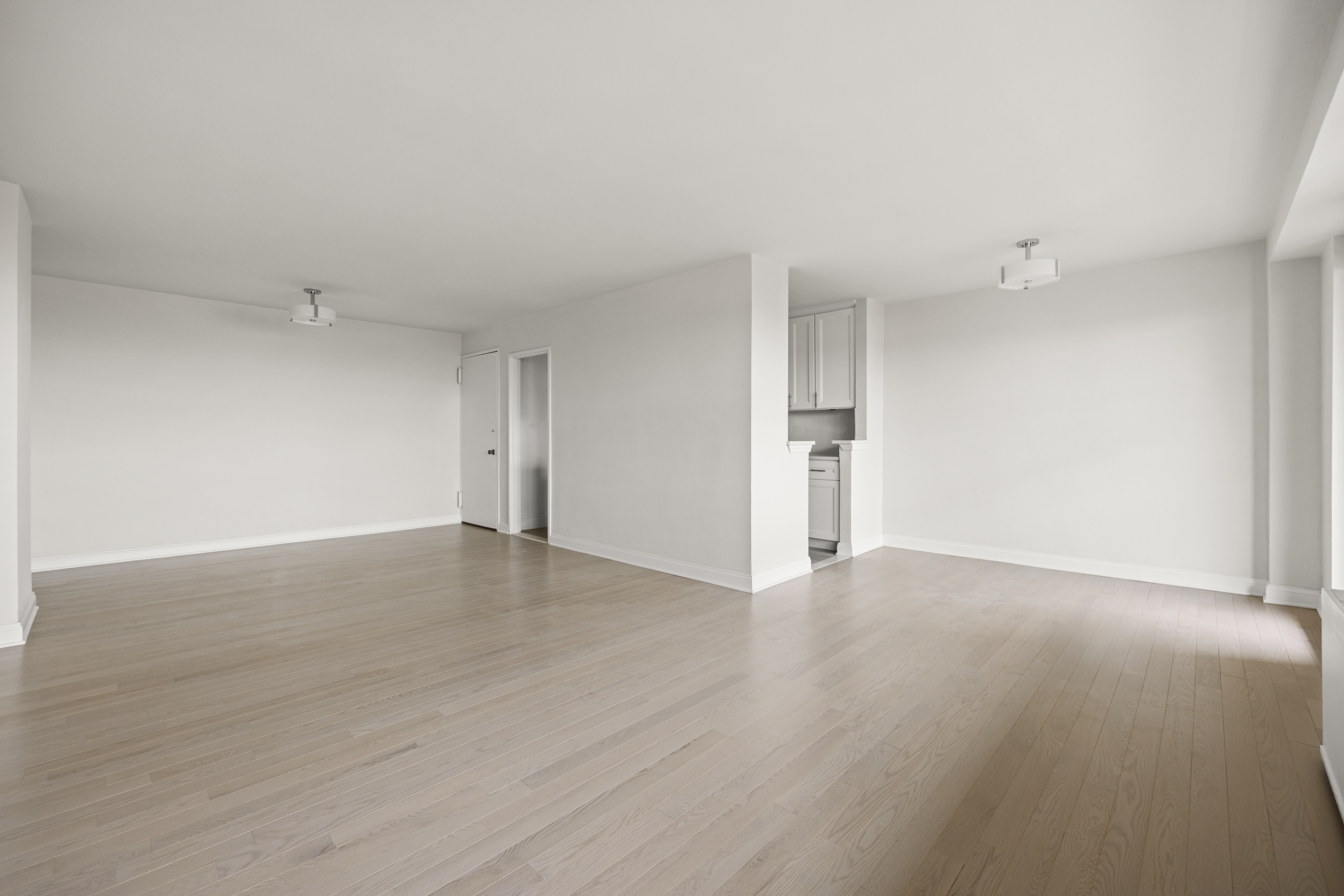 135 Ocean Parkway, Unit 9M Brooklyn, NY 11218 - Photo 15 of 18 a view of an empty room with wooden floor and a window