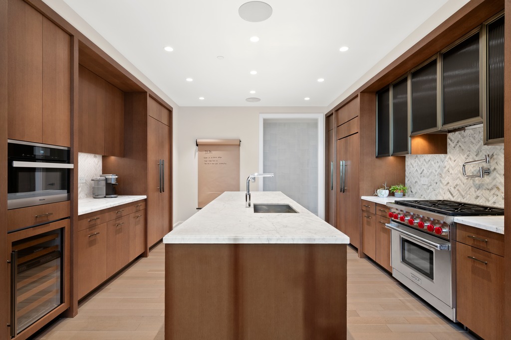 100 Barclay Street, Unit 21AD Manhattan, NY 10007 - Photo 6 of 40 a kitchen with stainless steel appliances granite countertop a stove a sink and a refrigerator