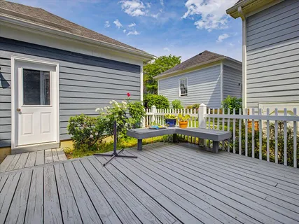 a front view of a house with a garden and plants
