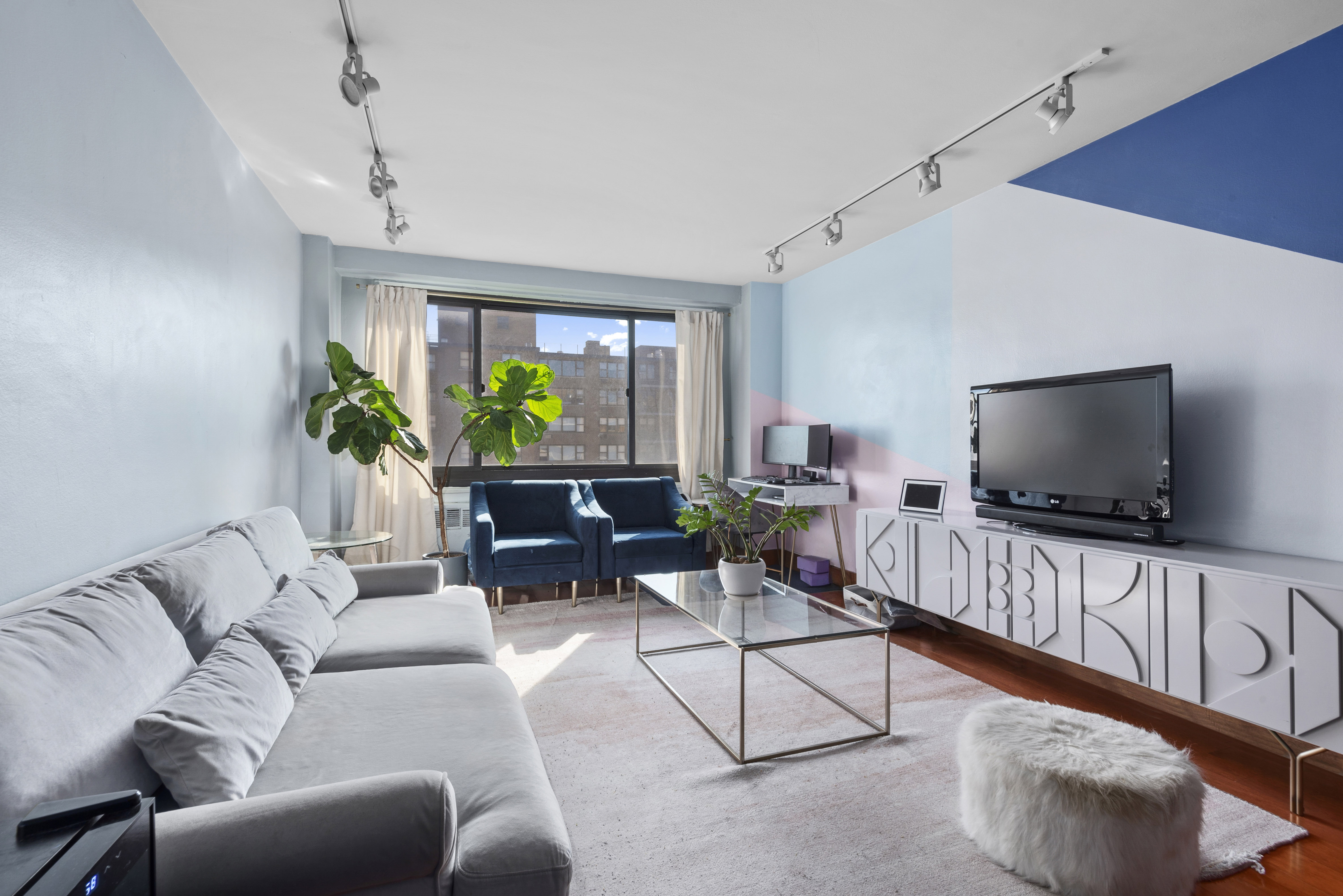 195 Willoughby Avenue, Unit 1411 Brooklyn, NY 11205 - Photo 2 of 6 a living room with furniture and a flat screen tv