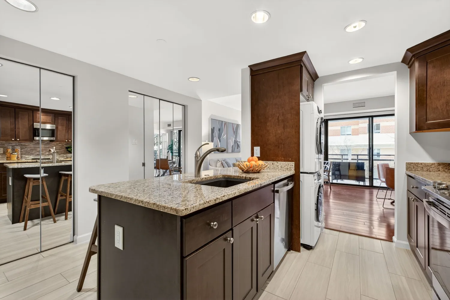 a kitchen with stainless steel appliances granite countertop a sink stove and refrigerator