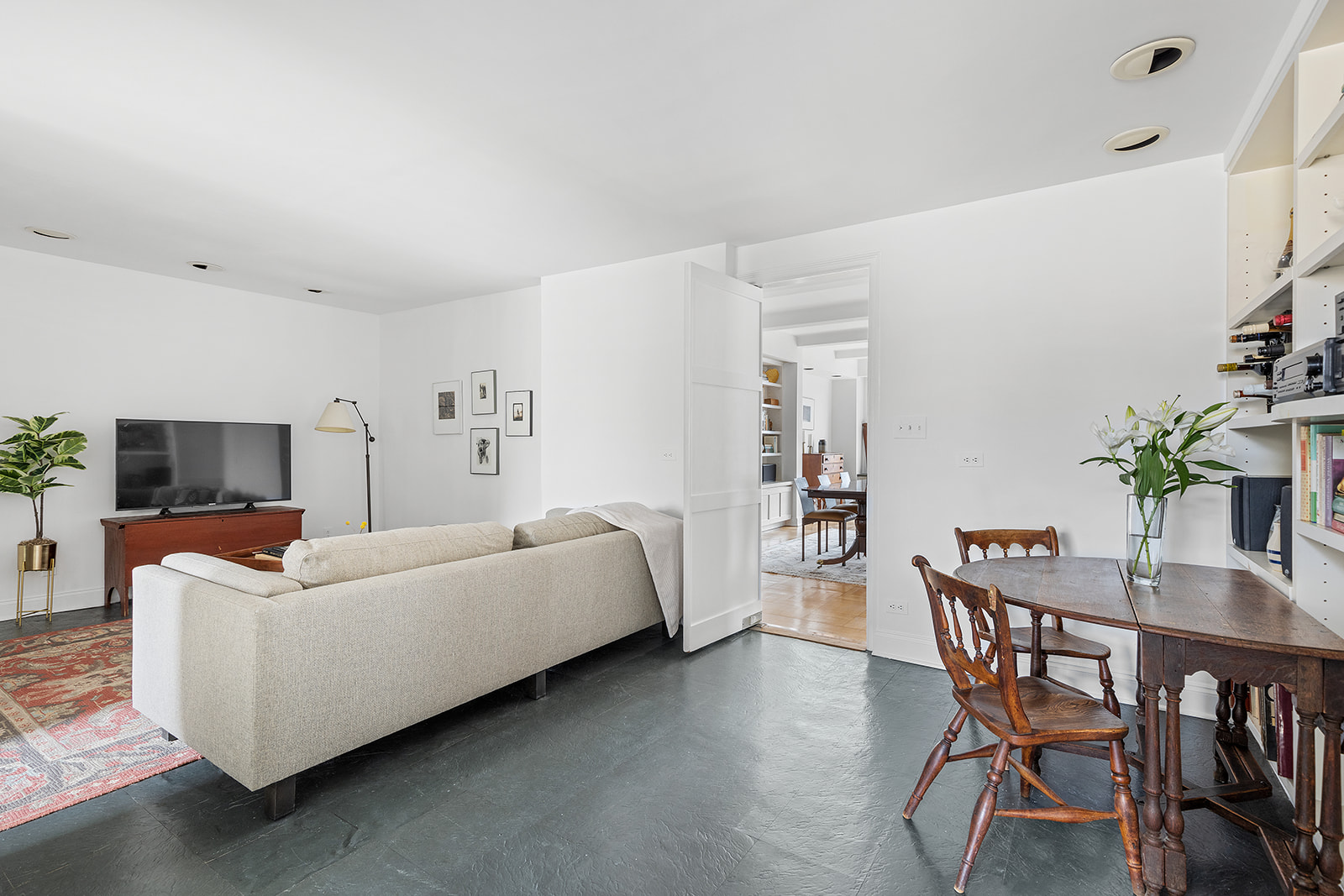 110-118 Riverside Drive, Unit 15A Manhattan, NY 10024 - Photo 7 of 17 a living room with furniture and a flat screen tv