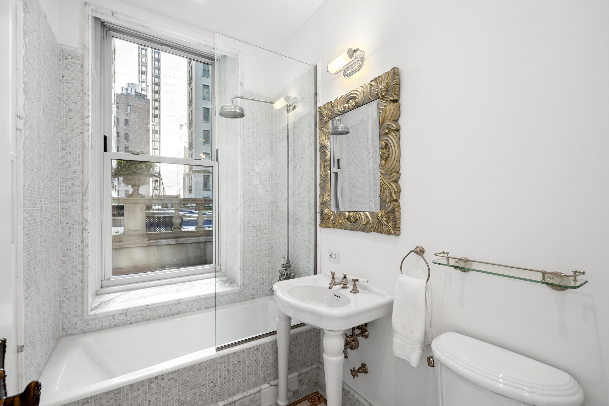 1 Central Park South, Unit 510 Manhattan, NY 10019 - Photo 15 of 23 a bathroom with a sink a toilet and shower
