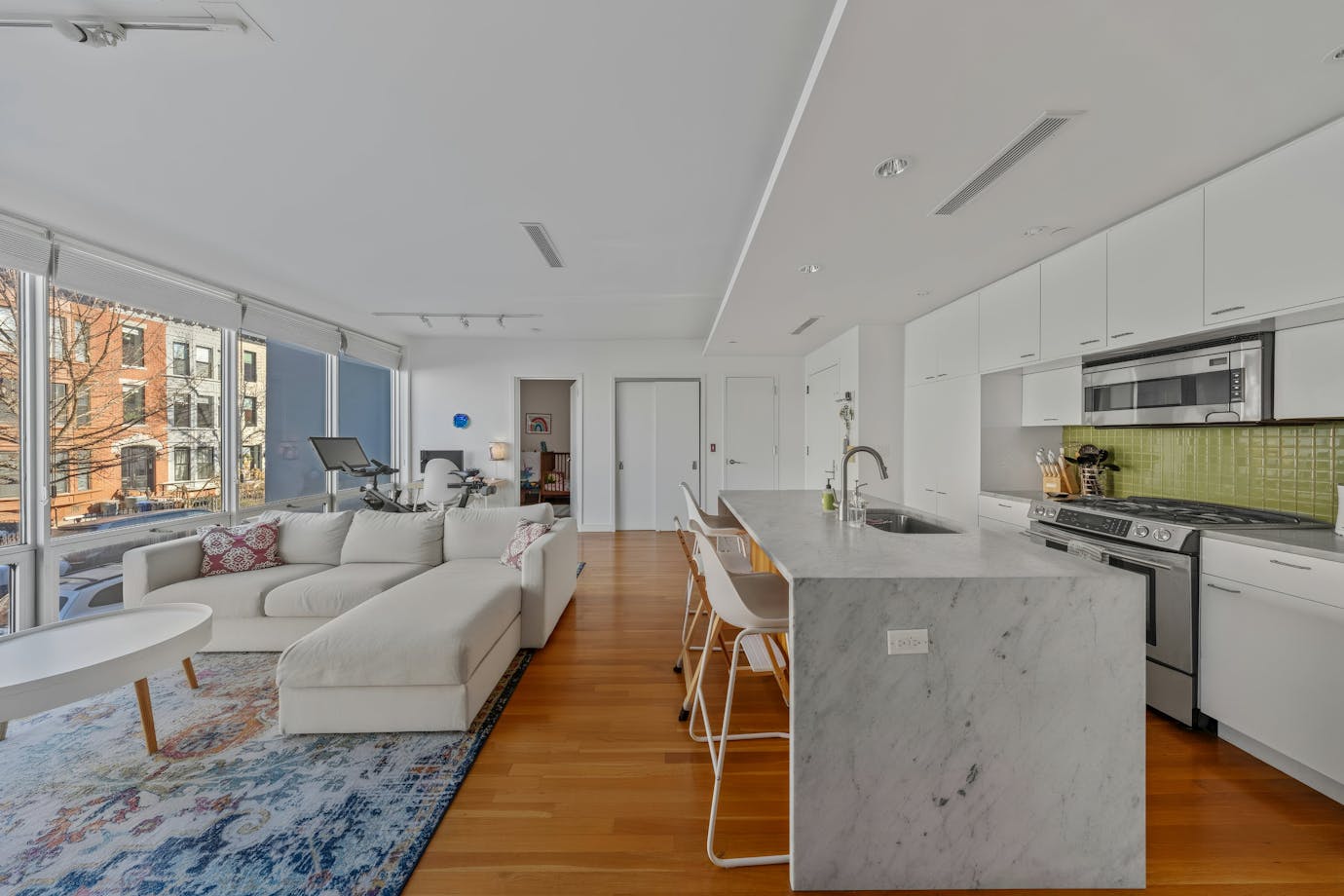 232 7th Street, Unit 2A Brooklyn, NY 11215 - Photo 1 of 8 a living room with stainless steel appliances furniture a rug and a large window