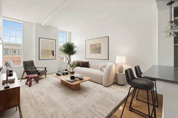 a living room with furniture and a potted plant on table