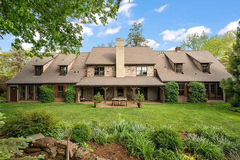 a front view of a building with a garden