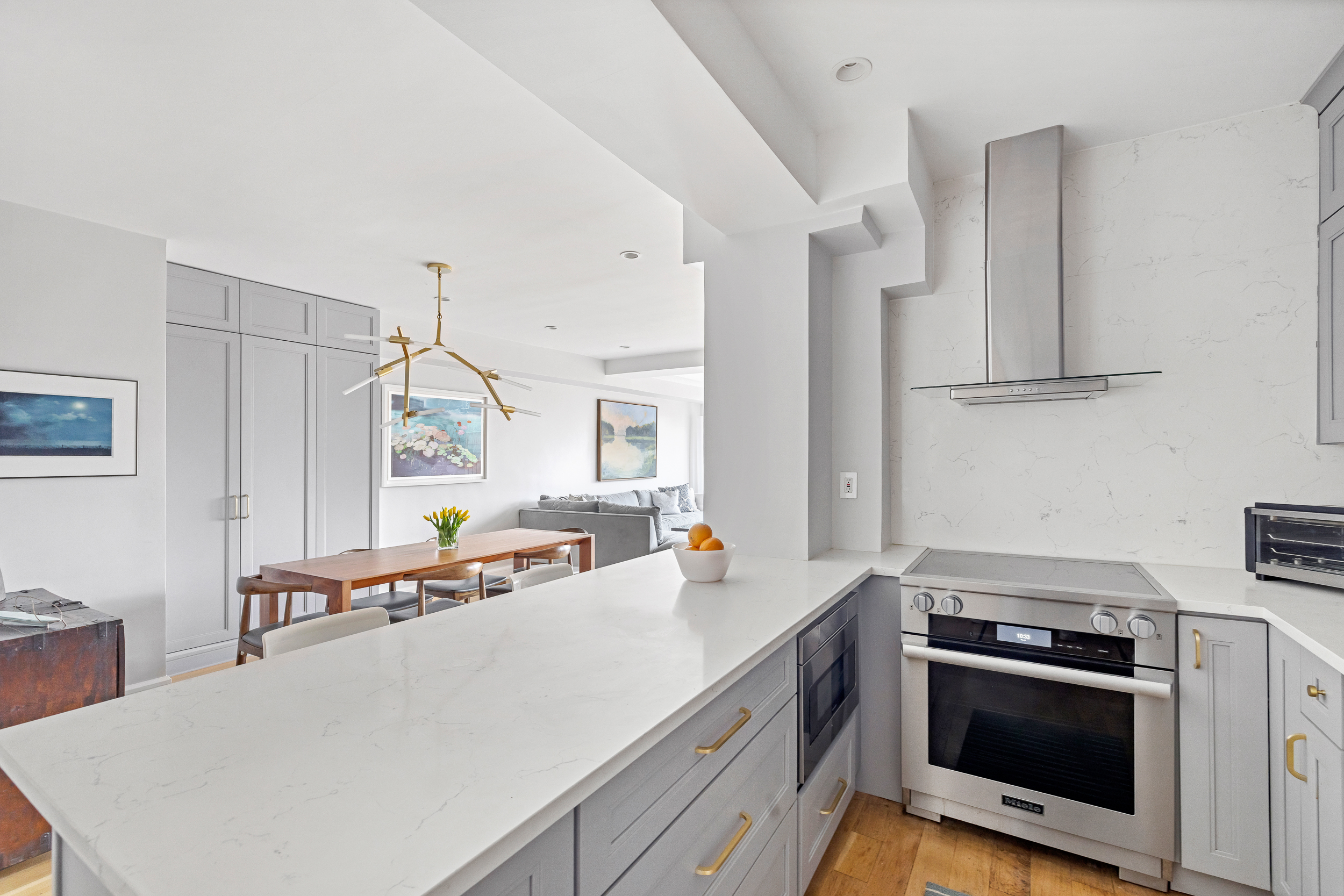 80 East End Avenue, Unit 17C Manhattan, NY 10028 - Photo 7 of 11 a kitchen with a stove a sink and a refrigerator