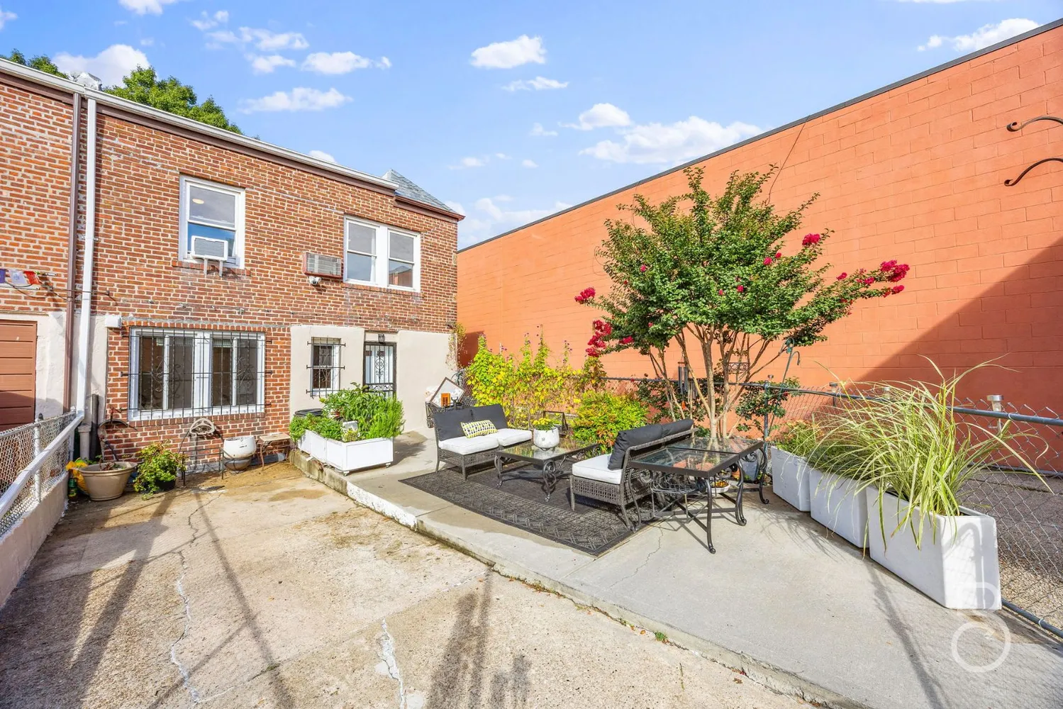 a view of a patio with plants and chairs