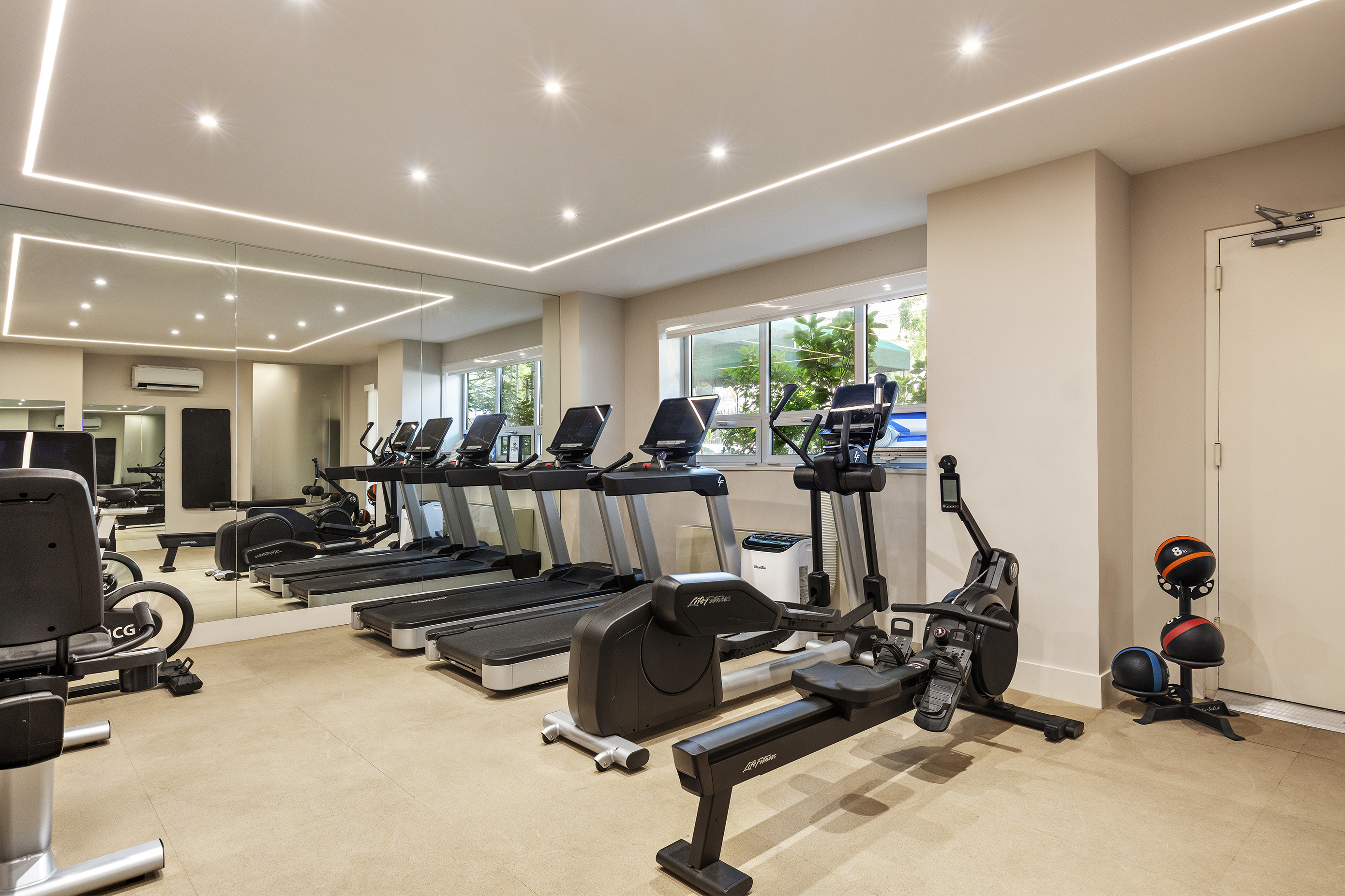 10 East 70th Street, Unit 3A Manhattan, NY 10021 - Photo 12 of 18 a room with gym equipment and a large window