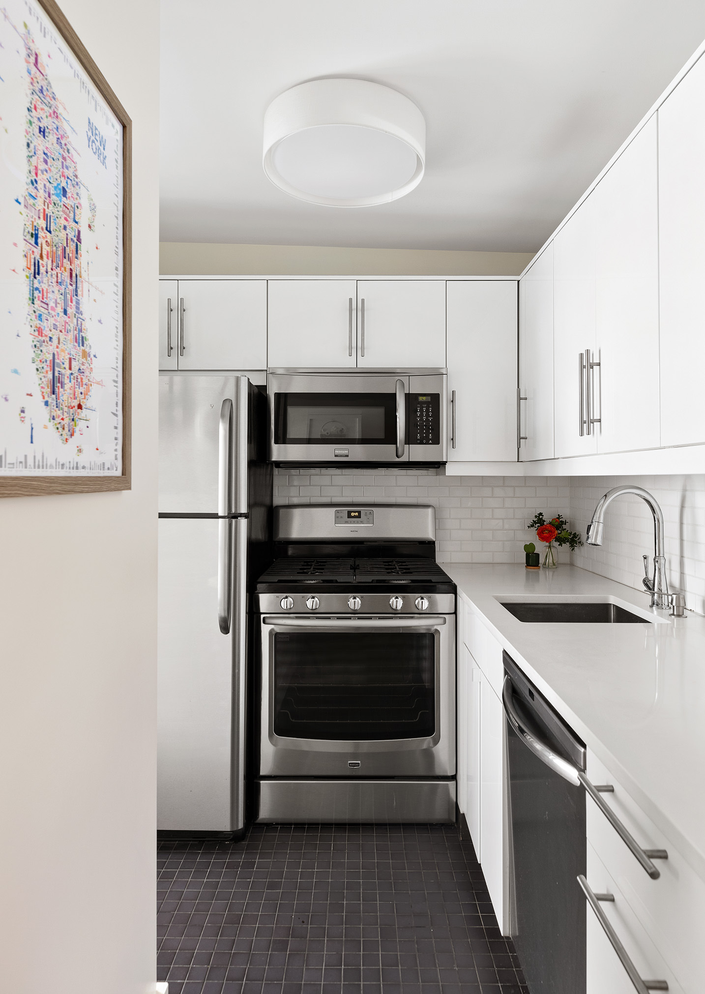 85 8th Avenue, Unit 5-H Manhattan, NY 10011 - Photo 4 of 11 a kitchen with cabinets stainless steel appliances and a sink