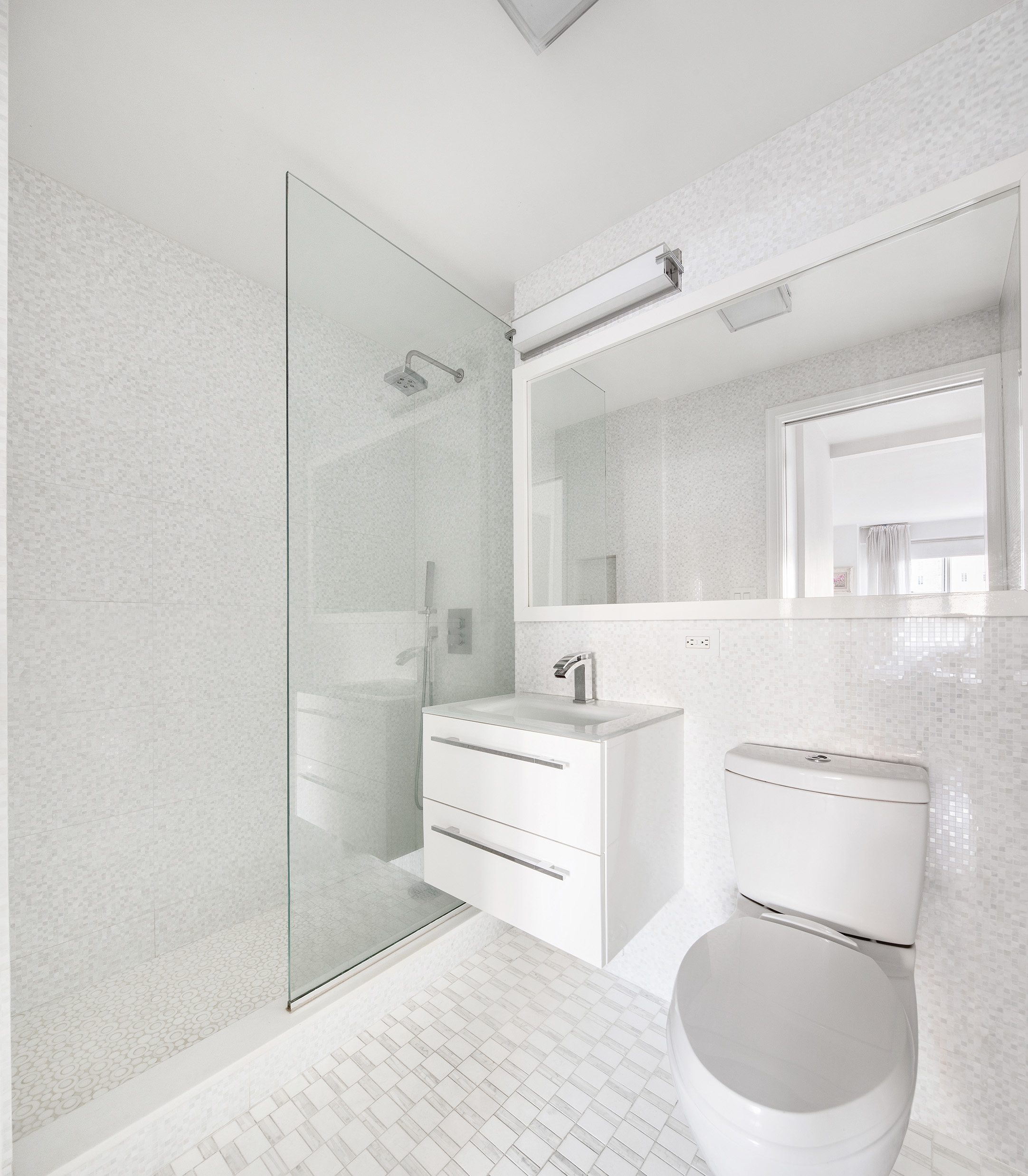 150 East 61st Street, Unit 7E Manhattan, NY 10065 - Photo 7 of 12 a bathroom with a sink a toilet and shower