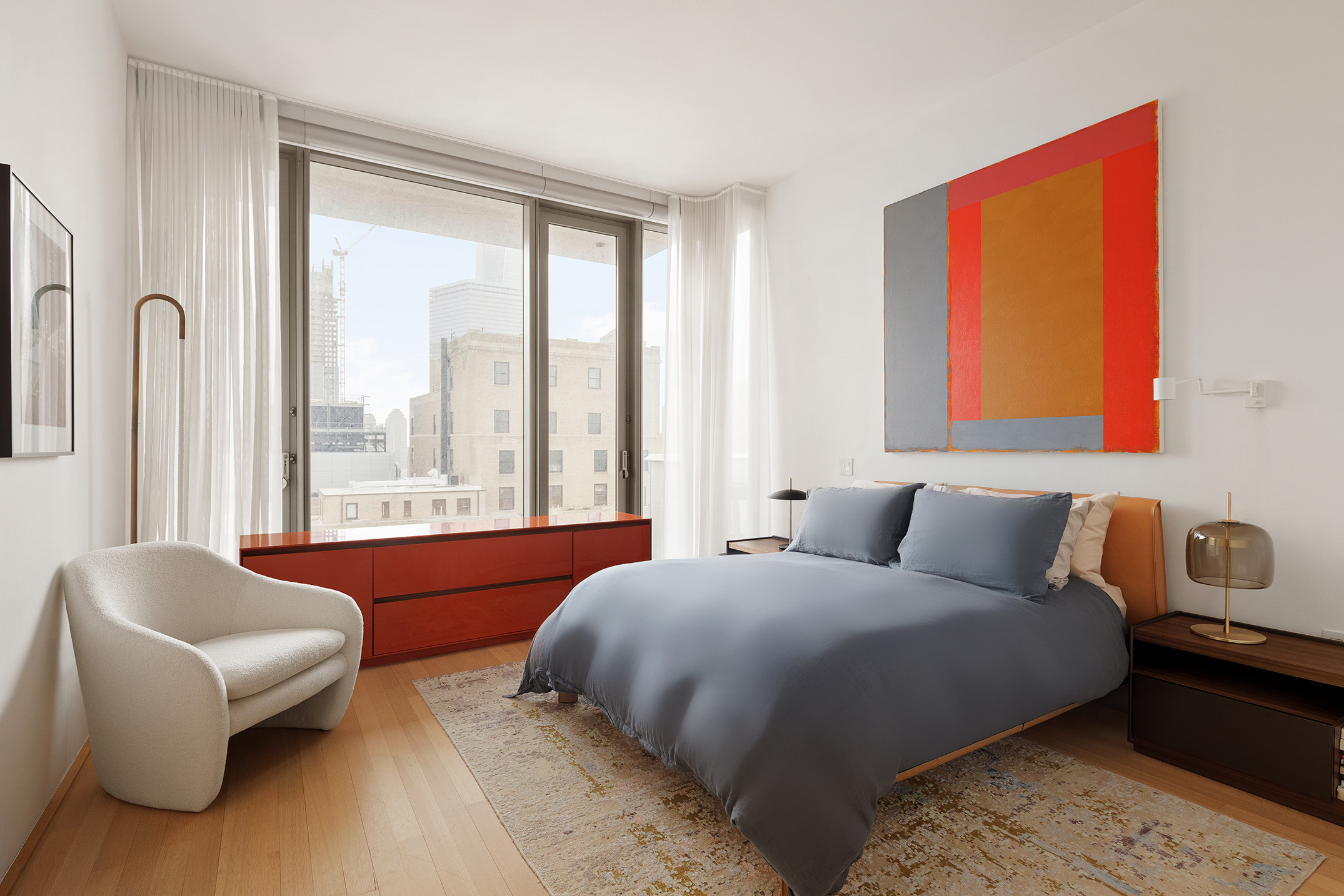 56 Leonard Street, Unit 21AWEST Manhattan, NY 10013 - Photo 4 of 11 a bedroom with a bed and a couch next to a window