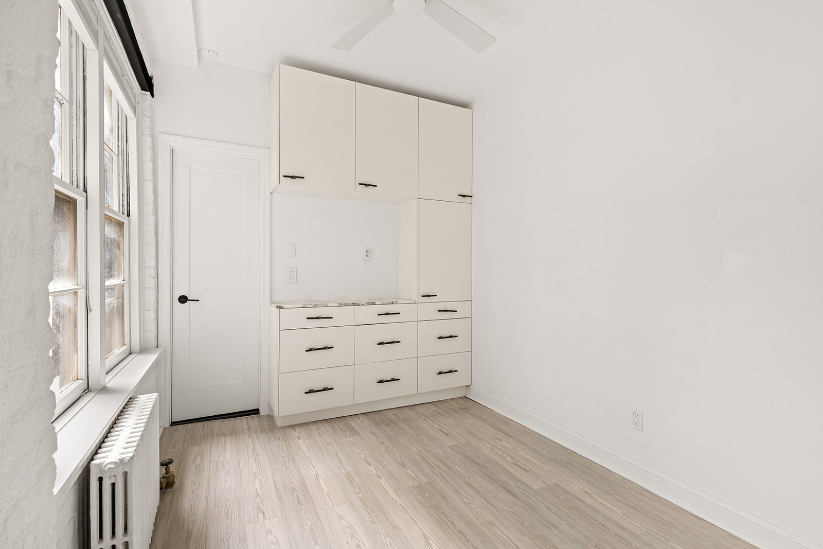 57 Thompson Street, Unit 2CD Manhattan, NY 10012 - Photo 8 of 13 an empty room with cabinet