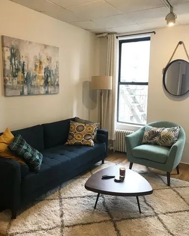 a living room with furniture and a window