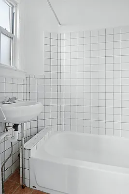 241 Himrod Street, Unit 3L Brooklyn, NY 11237 - Photo 5 of 5 a bathroom with a white bathtub and a sink