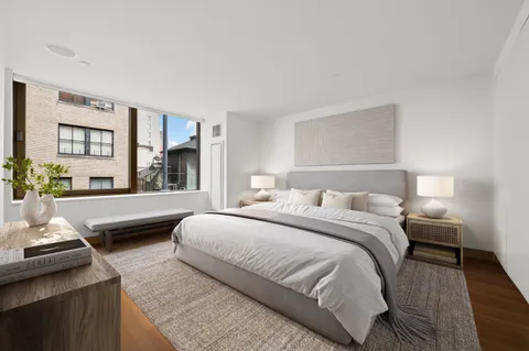 a bedroom with a bed and a couch