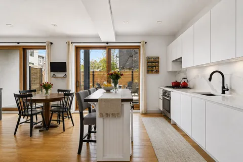 a kitchen with sink a table and chairs