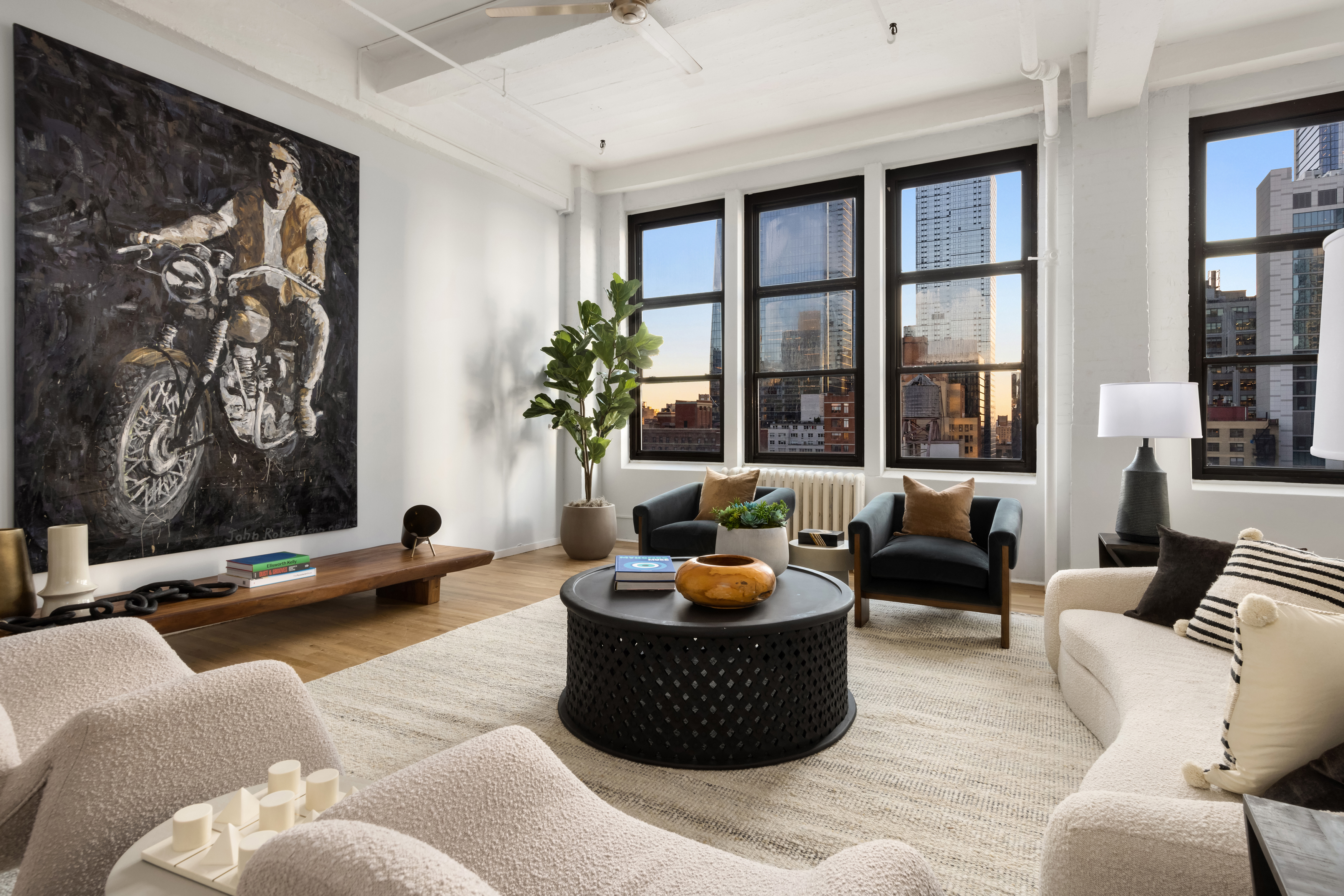 448 West 37th Street, Unit 12F Manhattan, NY 10018 - Photo 4 of 11 a living room with furniture and a potted plant