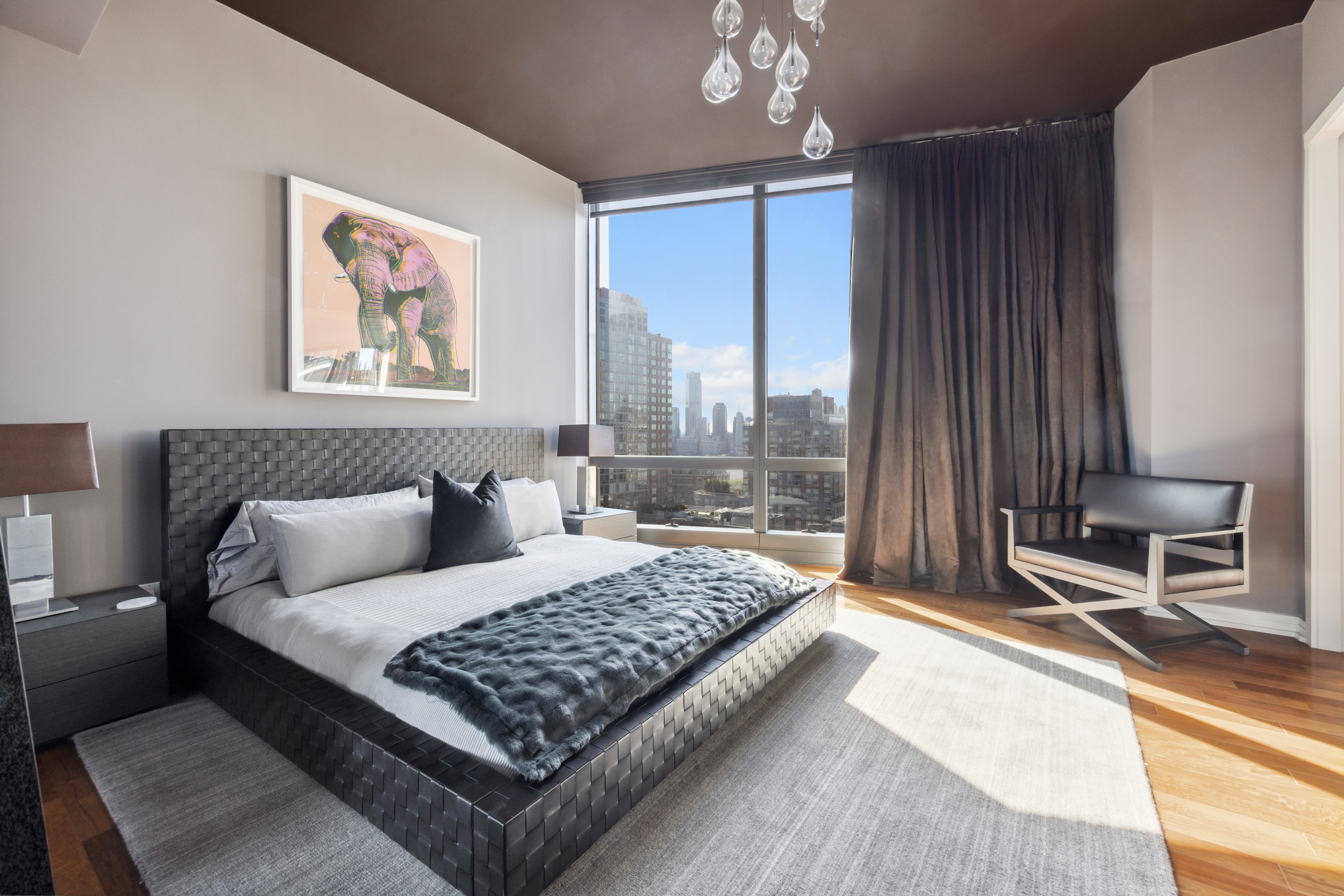 101 Warren Street, Unit 2220 Manhattan, NY 10007 - Photo 8 of 19 a living room with a bed furniture and next to a window