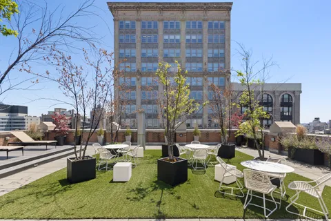 a view of a patio with dining table and chairs and potted plants