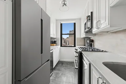 a kitchen with stainless steel appliances granite countertop a refrigerator and a sink