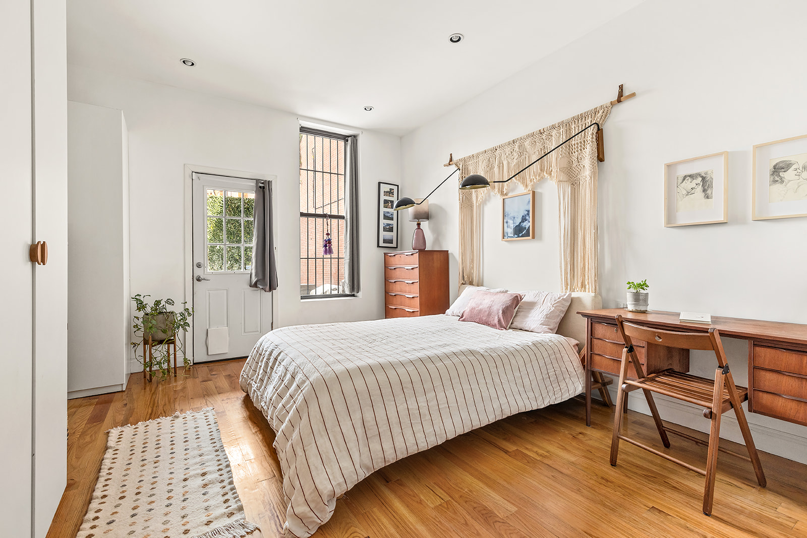 1153 Pacific Street, Unit 1 Brooklyn, NY 11216 - Photo 3 of 11 a bedroom with a bed and wooden floor