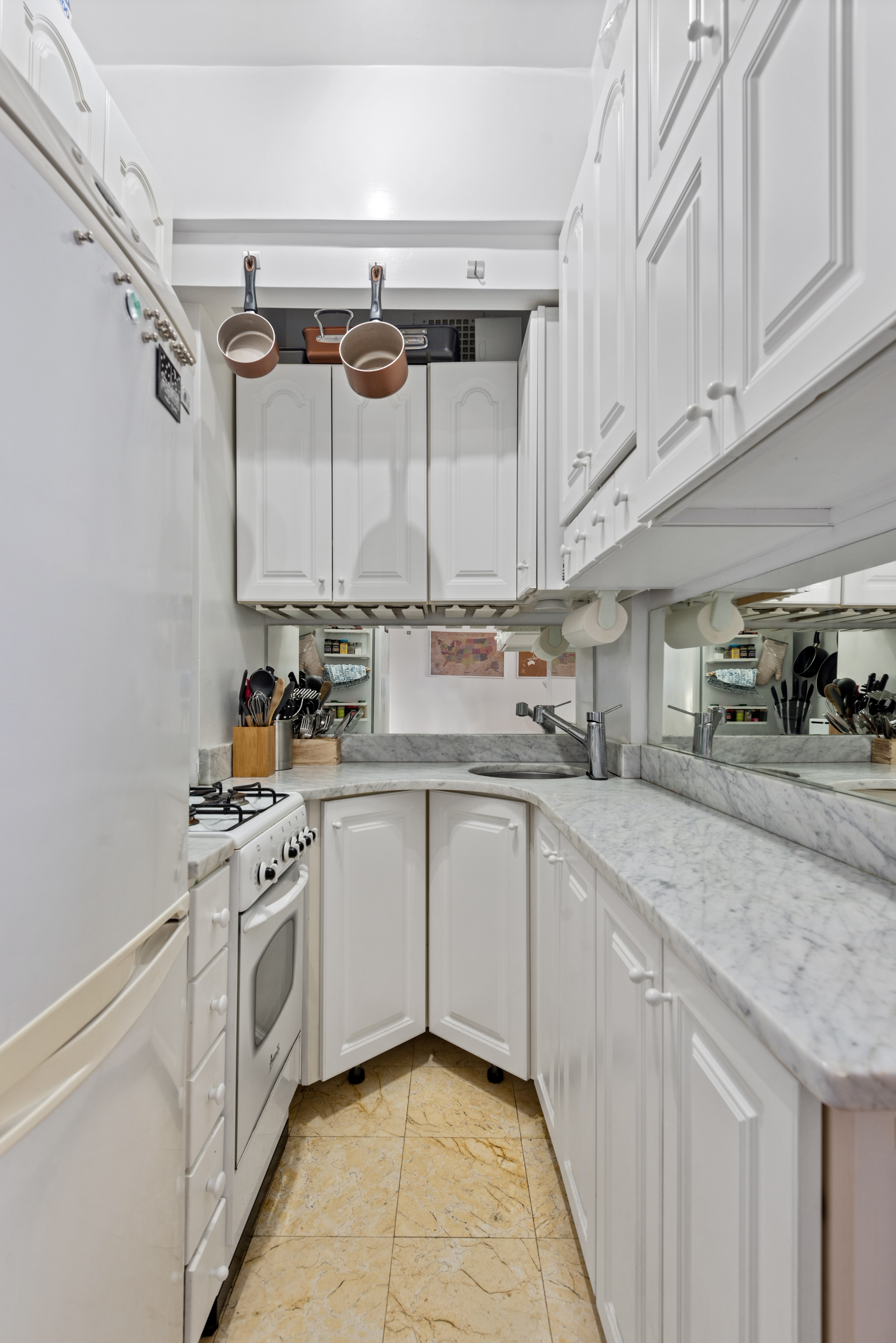225 Central Park West, Unit 619 Manhattan, NY 10024 - Photo 4 of 6 a kitchen with stainless steel appliances granite countertop a sink and cabinets