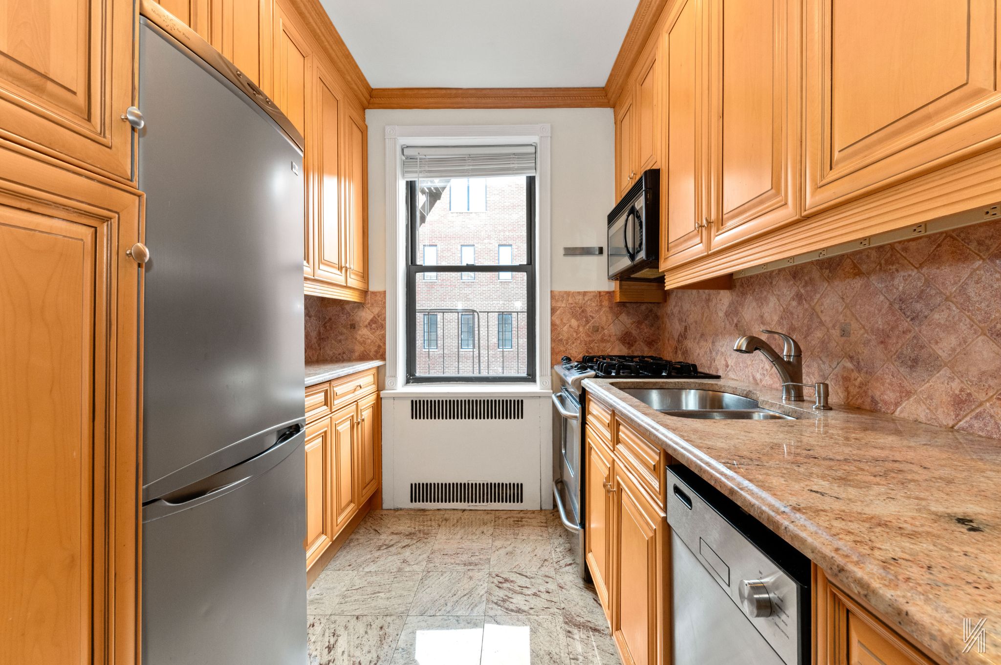 25-40 31st Avenue, Unit 6E Queens, NY 11106 - Photo 10 of 15 a kitchen with a sink stove and refrigerator