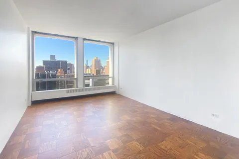 a spacious bedroom with a large bed and a couch