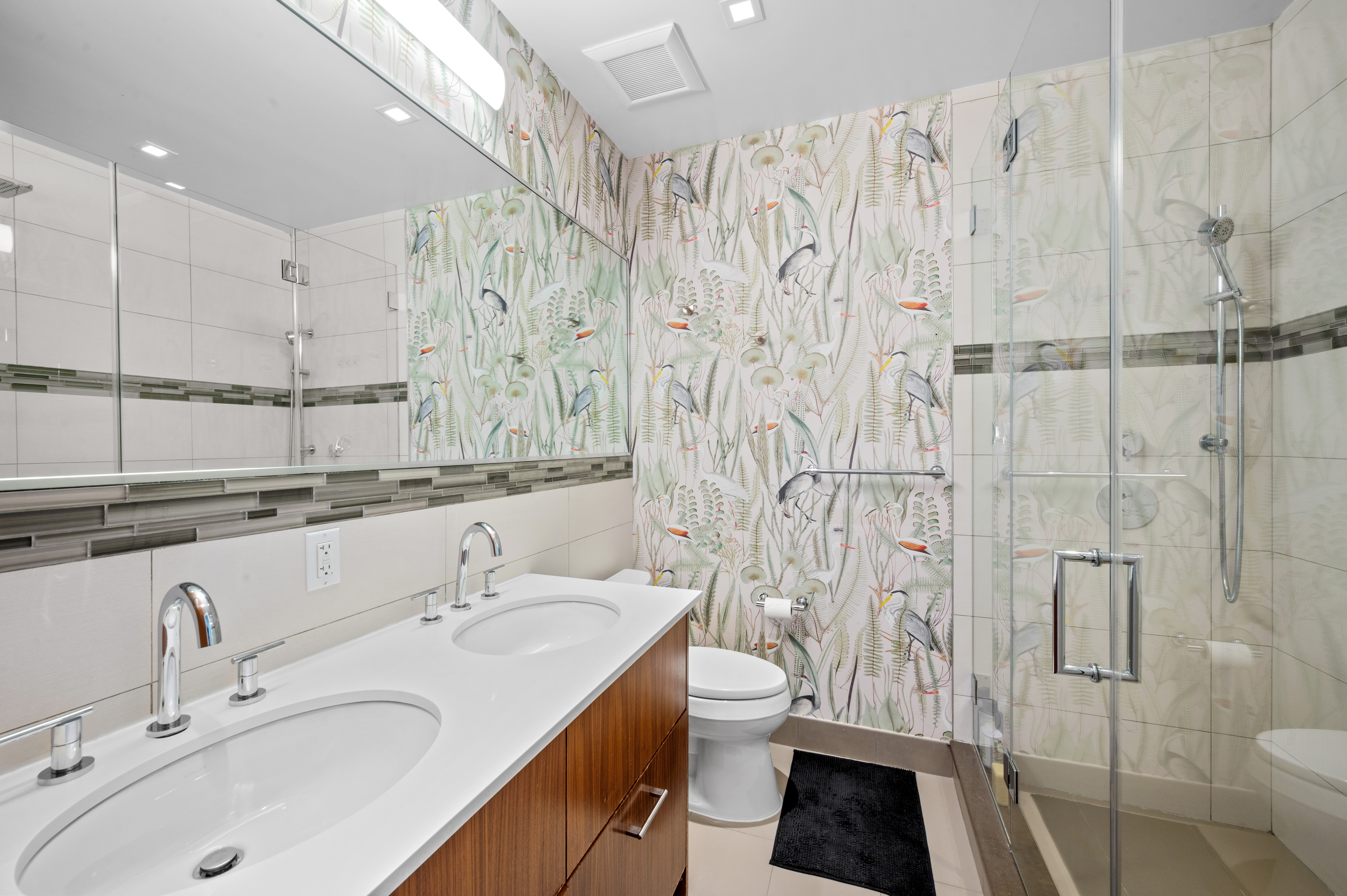 5-41 47th Road, Unit 2B Queens, NY 11101 - Photo 5 of 10 a bathroom with a sink toilet a mirror and shower