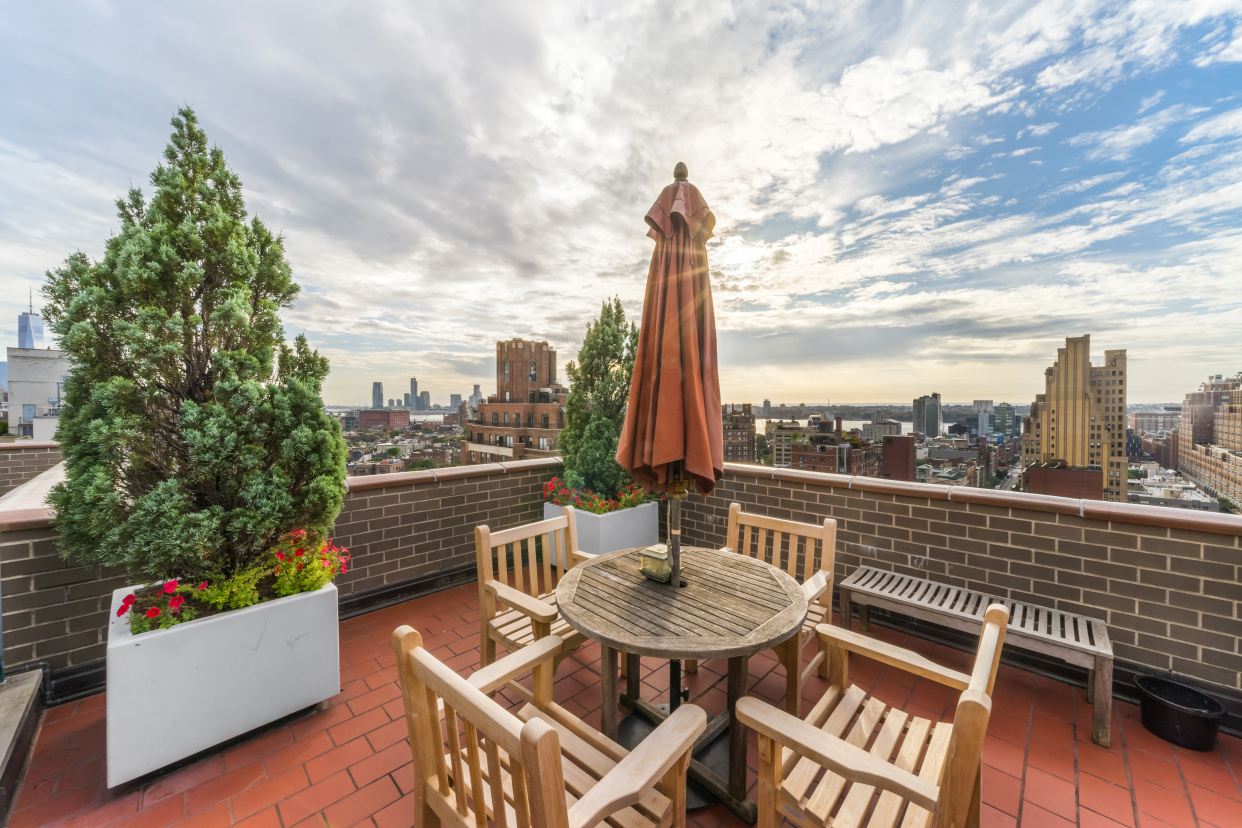 77 7th Avenue, Unit 12P Manhattan, NY 10011 - Photo 14 of 15 a view of a balcony with a table and chairs