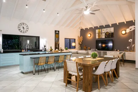 a dinning area with a table and chairs