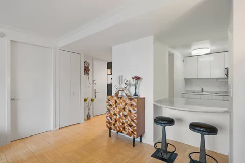 a kitchen with stainless steel appliances kitchen island granite countertop a refrigerator and a sink