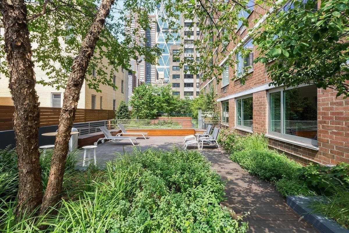 301 West 53rd Street, Unit 21B Manhattan, NY 10019 - Photo 14 of 20 a view of a house with a swimming pool