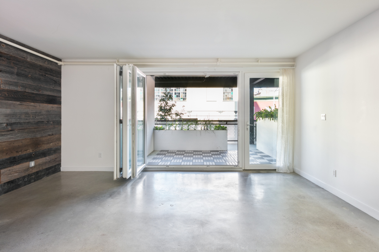 834 Sterling Place, Unit 203 Brooklyn, NY 11216 - Photo 1 of 12 a view of empty room with wooden floor and fan